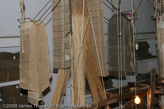 Jacqard Loom -- The pattern on the cloth is controlled by the series of punch cards.